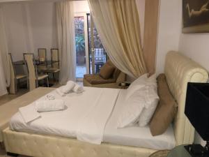 a white bed in a room with a room with at CALM SUITE in Sitia