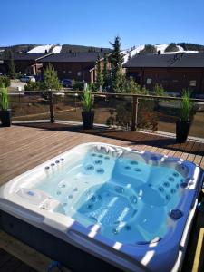 a hot tub sitting on top of a deck at Villa Peso1 - 9 henkilölle, HimosYkkösen alue in Jämsä