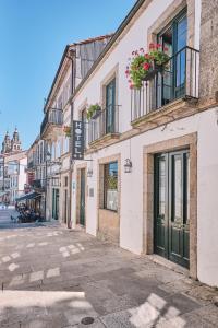 an empty street in a town with buildings at Hotel Entrecercas in Santiago de Compostela