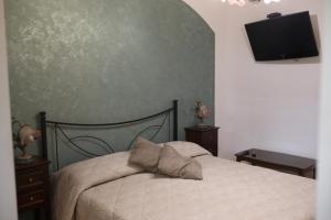 a bedroom with a bed and a flat screen tv at Ancora del Salento in Lecce