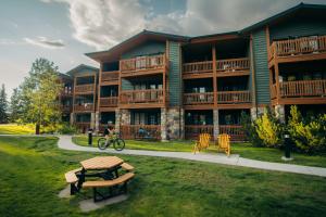 a person riding a bike in front of a building at Lake Louise Inn in Lake Louise