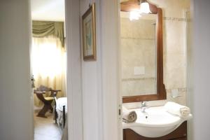 a bathroom with a sink and a mirror at Ancora del Salento in Lecce