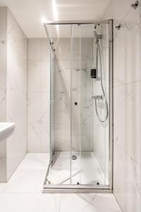 a shower with a glass door in a bathroom at Smartflats - the City Antwerp in Antwerp