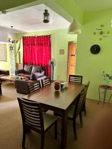 a living room with a table and a couch at Cool Living at GVR Landed Unit in Genting Highlands