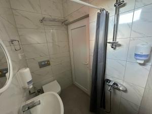 a bathroom with a shower and a toilet and a sink at KOZA HOSTEL Coffee & Chill in Çekirge