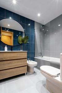 a bathroom with a sink toilet and a mirror at La Quinta Esencia by Unique Rooms in Burgos