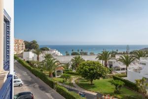 a view of the ocean from the balcony of a building at Quinta Pedra dos Bicos By Albufeira Rental in Albufeira