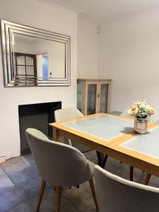 a dining room with a table and chairs and a mirror at 17 Howard Road. Southampton in Southampton