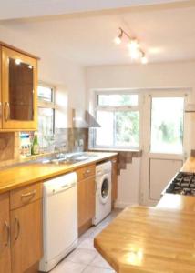 a kitchen with a sink and a washer and dryer at 17 Howard Road. Southampton in Southampton