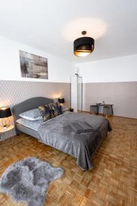 a bedroom with a large bed and a wooden floor at ClickTheFlat Norblin Factory Apart Rooms in Warsaw