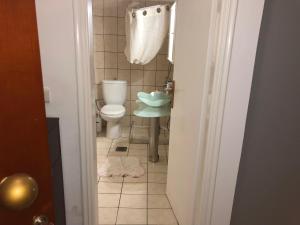 a small bathroom with a toilet and a sink at CALM SUITE in Sitia