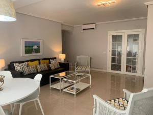 a living room with a couch and a table at SeaMed in Málaga