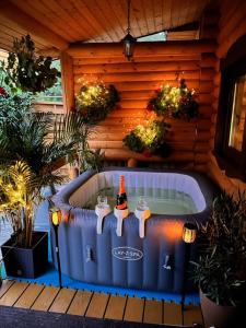 a hot tub with a bottle of wine in it at Domy z Bala - Bungalow 50 metrów od Plaży spa domki ogrzewane in Dziwnówek