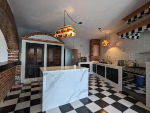 a large kitchen with a checkered floor at La Joya Azul SMA - LGBTQS in San Miguel de Allende