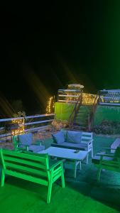 a group of benches sitting on the beach at night at Villat Grand in Peje