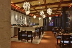 a restaurant with a bar and chairs and lights at Wind Creek Bethlehem Casino & Resort in Bethlehem
