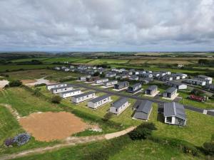 an aerial view of a village with houses and a road at Valley View with a luxurious hot tub in Newquay