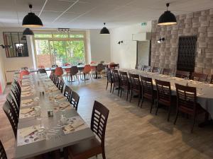 a dining room with long tables and chairs and a room with tables and chairsktop at LOGIS HOTEL & RESTAURANT Le CARNOT in Die