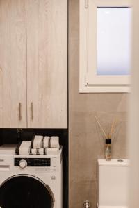 a kitchen with a white stove and a white microwave at Dimofontas - Hub Thiseio & Gkazi in Athens