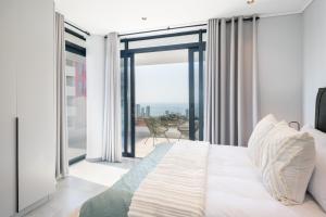 a bedroom with a bed and a large window at Luxury Bellagio 302 with Sea Views and Inverter in Durban +46 photos