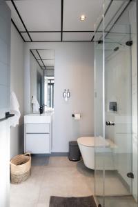 a bathroom with a tub and a toilet and a sink at Luxury Bellagio 302 with Sea Views and Inverter in Durban