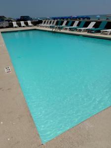 una gran piscina de agua azul con tumbonas en Kingfisher Inn en Myrtle Beach