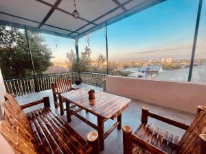 a table and chairs on a balcony with a view at Vintage Home in Kutaisi