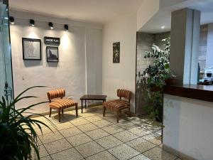 a waiting room with two chairs and a table at Hotel Hanna in Mar del Plata