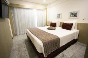 a bedroom with a large bed in a room at Nobile Residences Maria Frazão in Recife