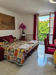 a bedroom with a bed and a large window at riva vacanze in Riva Ligure