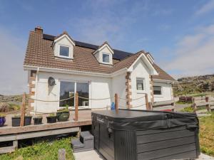 a house with a black trash can in front of it at Beachview in Oldshoremore