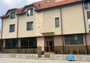 a building with a blue door in front of it at Hotel BLISS Sofia Airport Self Check In in Kazichene