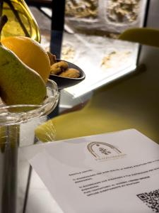 a table with a bowl of fruit and a plate of food at Palazzo Maqueda in Palermo +58 photos