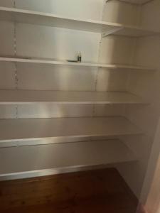 a shelf in a room with white shelves at Pokoj single in Zlín