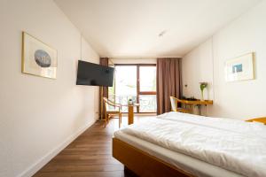 Postel nebo postele na pokoji v ubytování CityHotel Feuerbach