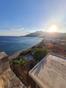 a view of the ocean from a house at VILLA PETRINO in Tsoútsouros