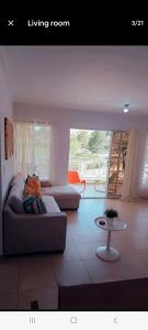 a living room with a couch and a table at Juan Dolio Guababerry Resort in Juan Dolio