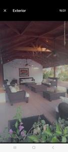 a pavilion with couches and tables on a patio at Juan Dolio Guababerry Resort in Juan Dolio