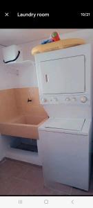 a kitchen with a white stove and a sink at Juan Dolio Guababerry Resort in Juan Dolio