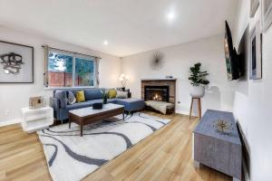 a living room with a blue couch and a fireplace at Convenient Quiet Home for Family Business Trip in Newcastle