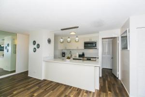 an empty kitchen with white walls and wooden floors at Discovery Bay 3513 in Honolulu