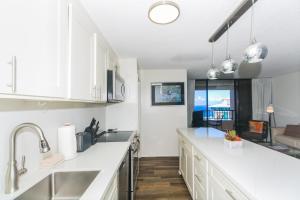 a kitchen with white cabinets and a large counter top at Discovery Bay 3513 in Honolulu
