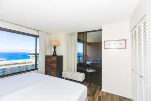 a bedroom with a bed and a view of the ocean at Discovery Bay 3513 in Honolulu +14 photos