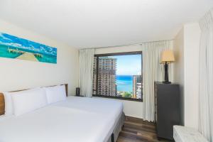 a bedroom with a bed and a large window at Discovery Bay 3513 in Honolulu