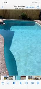 a large swimming pool with blue water in a building at Cozy Guest House Florida, Tamarac in Tamarac