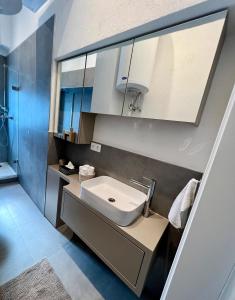 a bathroom with a sink and white cabinets at Wohnung in Graz in Graz