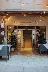 eine offene Tür eines Gebäudes mit Tischen und Stühlen in der Unterkunft Restauracja & Hotel Polowczyk 