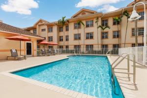 a swimming pool in front of a building at Residence Inn West Palm Beach in West Palm Beach