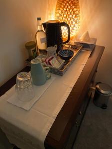 a table with a counter top with a tea set on it at Starlight Cottage Room Only In Glastonbury in Glastonbury