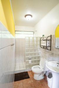 a bathroom with a toilet and a sink at Heliconia Island in Sarapiquí